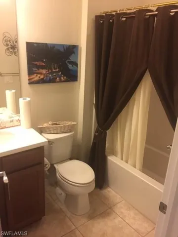 a white toilet sitting next to a bathroom sink