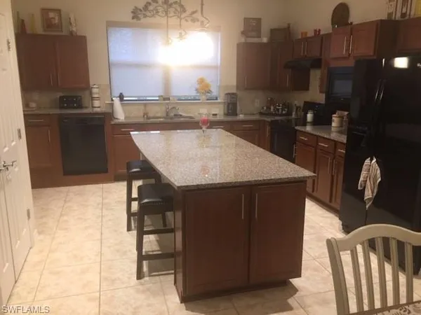 a kitchen with a sink cabinets and appliances