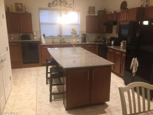 a kitchen with a sink cabinets and appliances