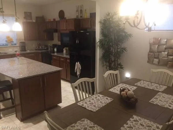 a kitchen with a table chairs and a stove
