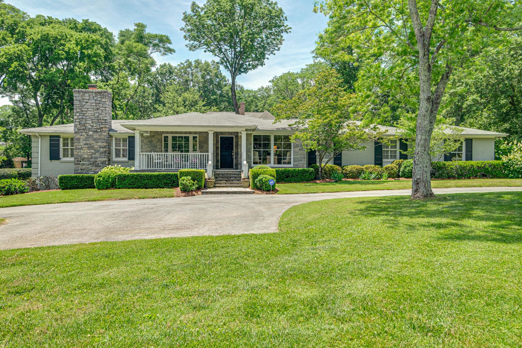 129 Cheek Road Nashville, TN 37205 - Photo 1 of 30 a view of a house with a big yard and large trees