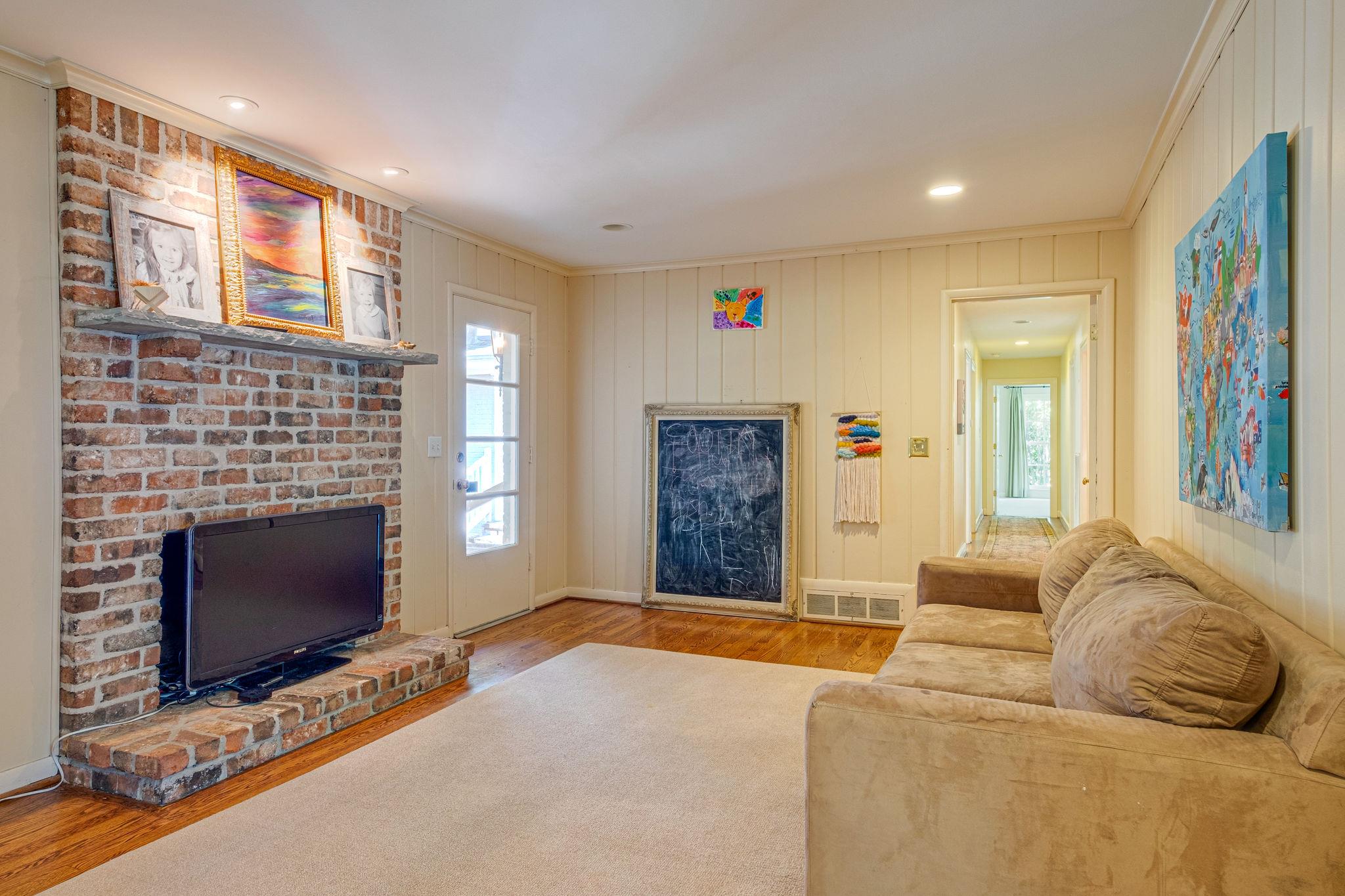 129 Cheek Road Nashville, TN 37205 - Photo 13 of 30 a living room with furniture flat screen tv and a fireplace