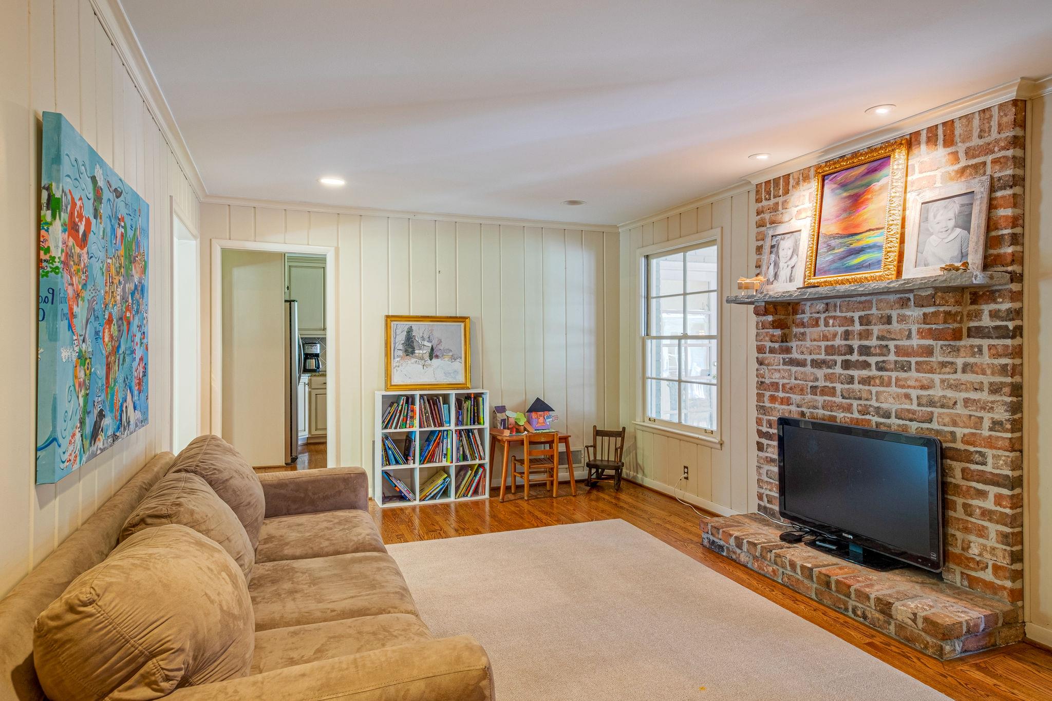 129 Cheek Road Nashville, TN 37205 - Photo 14 of 30 a living room with furniture a flat screen tv and a fireplace