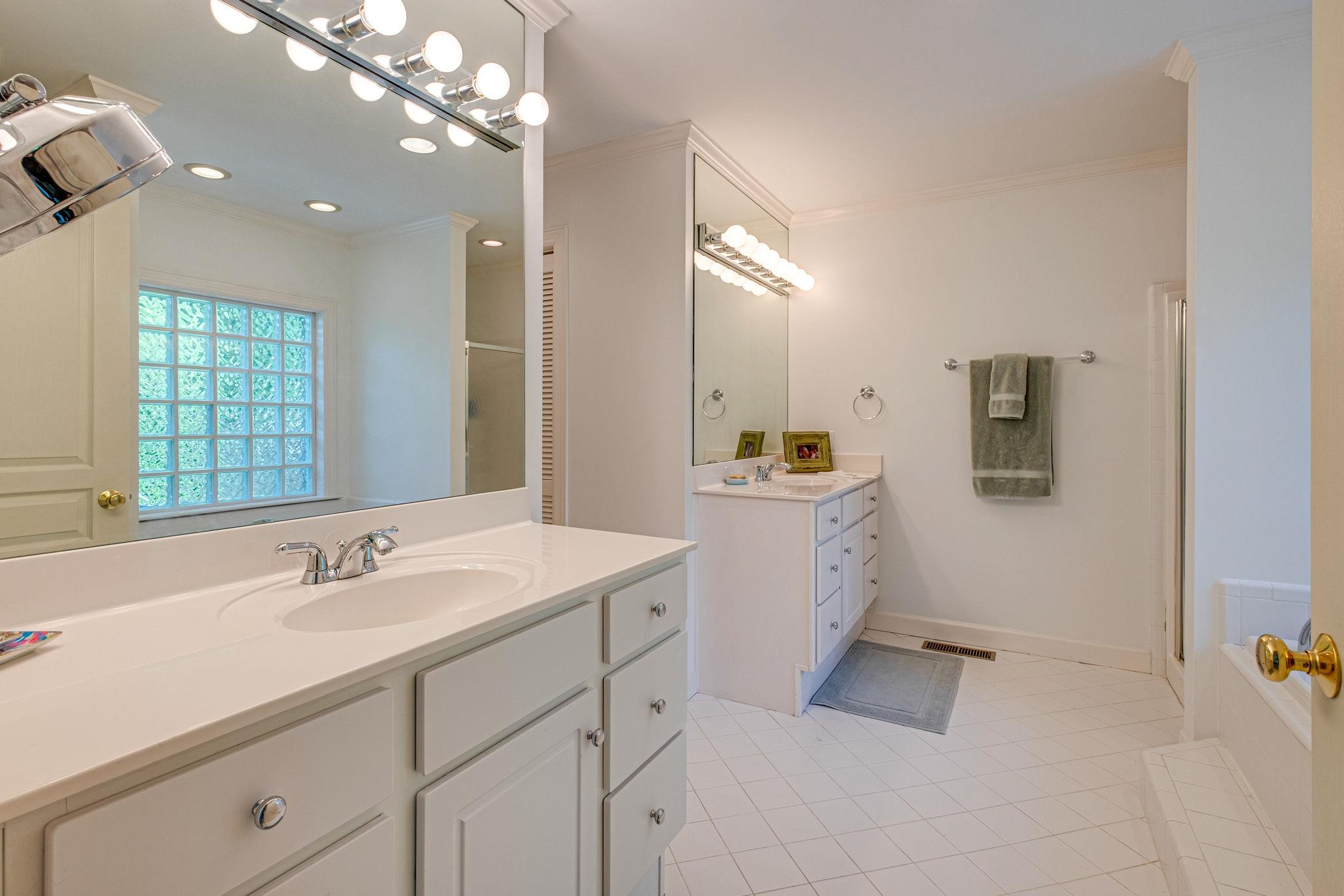 129 Cheek Road Nashville, TN 37205 - Photo 19 of 30 a spacious bathroom with a double vanity sink a mirror and shower