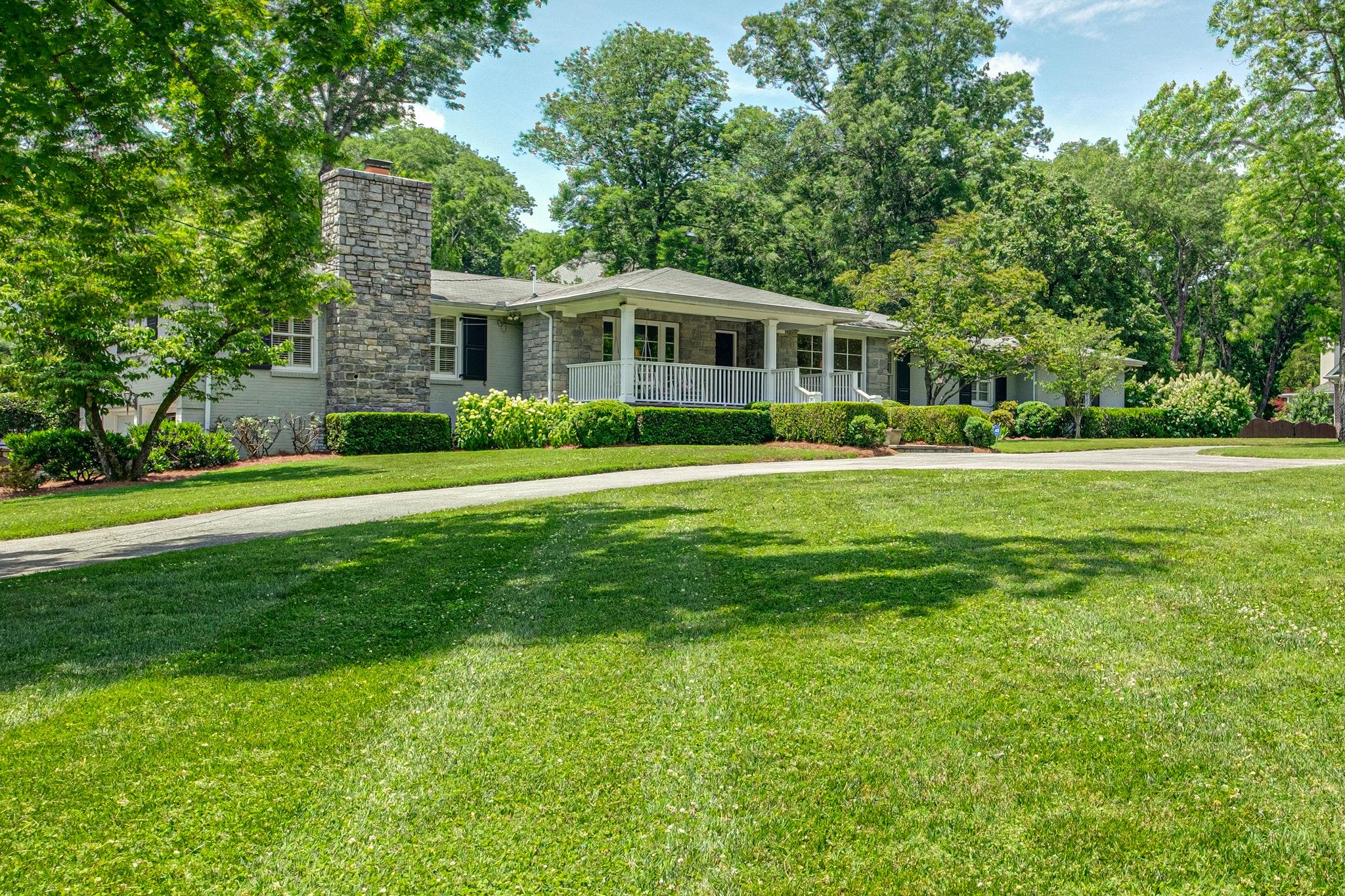 129 Cheek Road Nashville, TN 37205 - Photo 2 of 30 a front view of a house with a garden