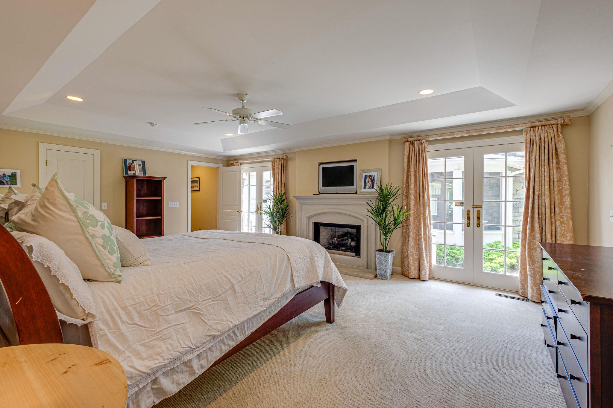 129 Cheek Road Nashville, TN 37205 - Photo 21 of 30 a spacious bedroom with a bed and a fireplace