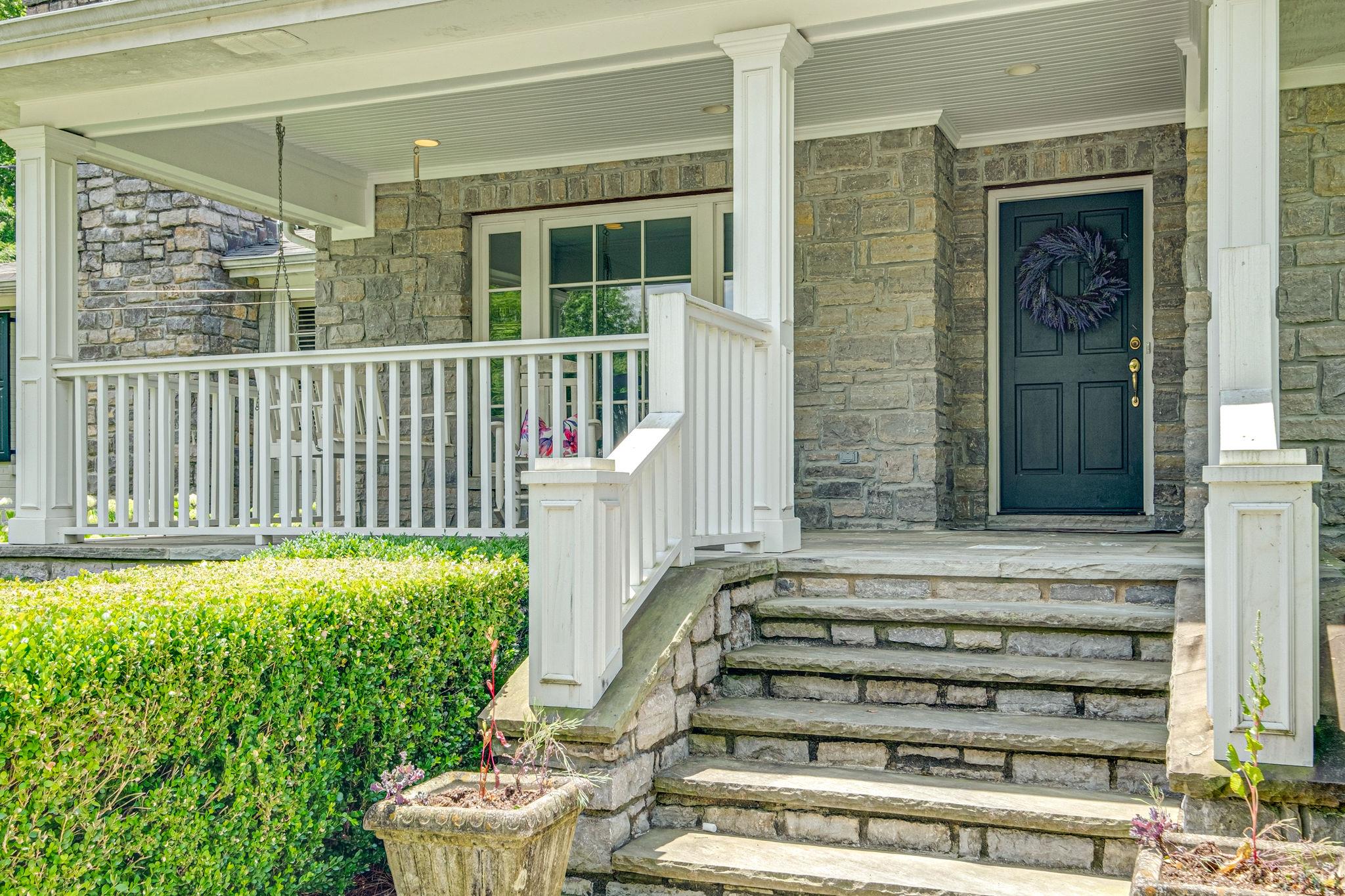 129 Cheek Road Nashville, TN 37205 - Photo 3 of 30 a front view of a house with a garden