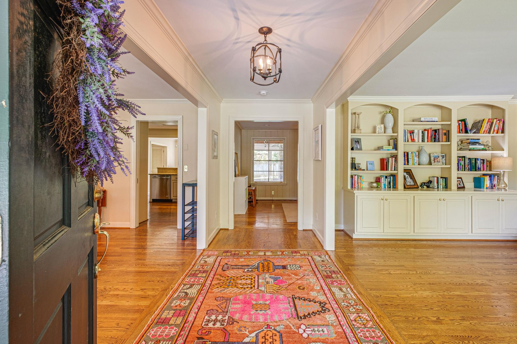 129 Cheek Road Nashville, TN 37205 - Photo 4 of 30 a hallway with beautiful frames and flower vase