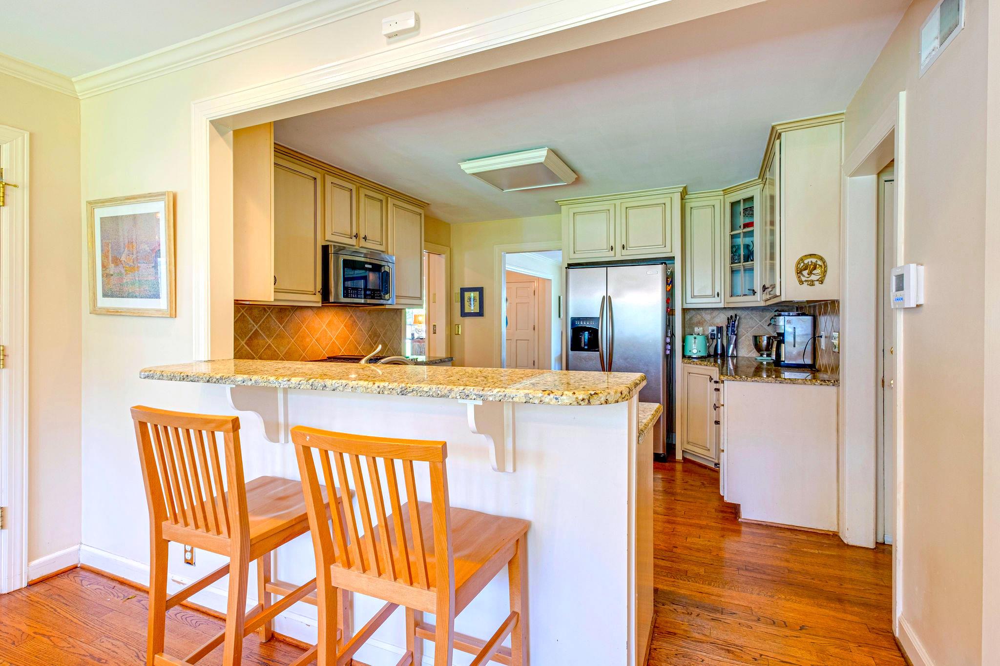 129 Cheek Road Nashville, TN 37205 - Photo 10 of 30 a kitchen with a table chairs refrigerator and microwave