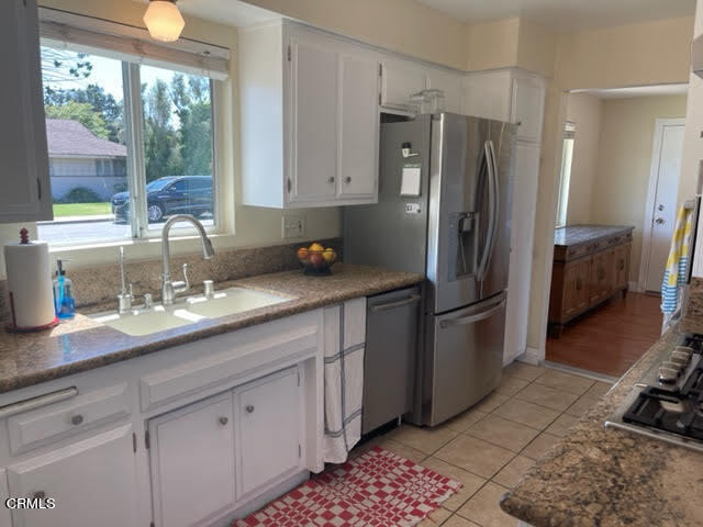 1215 Maple Street Santa Paula, CA 93060 - Photo 14 of 15 a kitchen with stainless steel appliances a sink stove and refrigerator