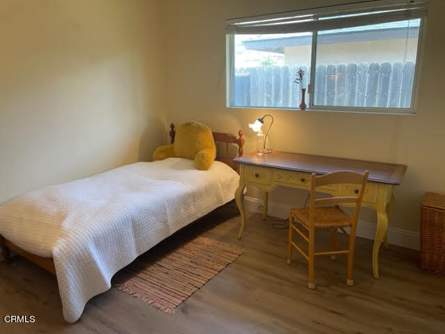 1215 Maple Street Santa Paula, CA 93060 - Photo 8 of 15 a bedroom with a bed and wooden floor