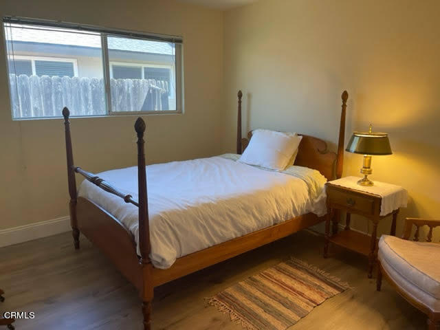 1215 Maple Street Santa Paula, CA 93060 - Photo 9 of 15 a bedroom with a bed and wooden floor
