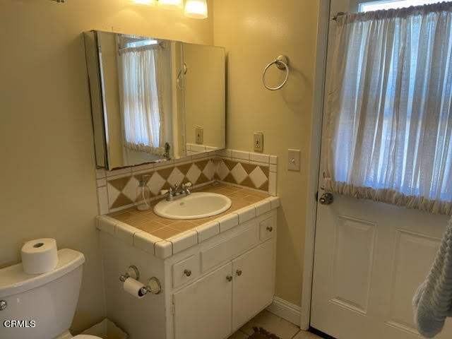 1215 Maple Street Santa Paula, CA 93060 - Photo 10 of 15 a bathroom with a sink a toilet and a mirror