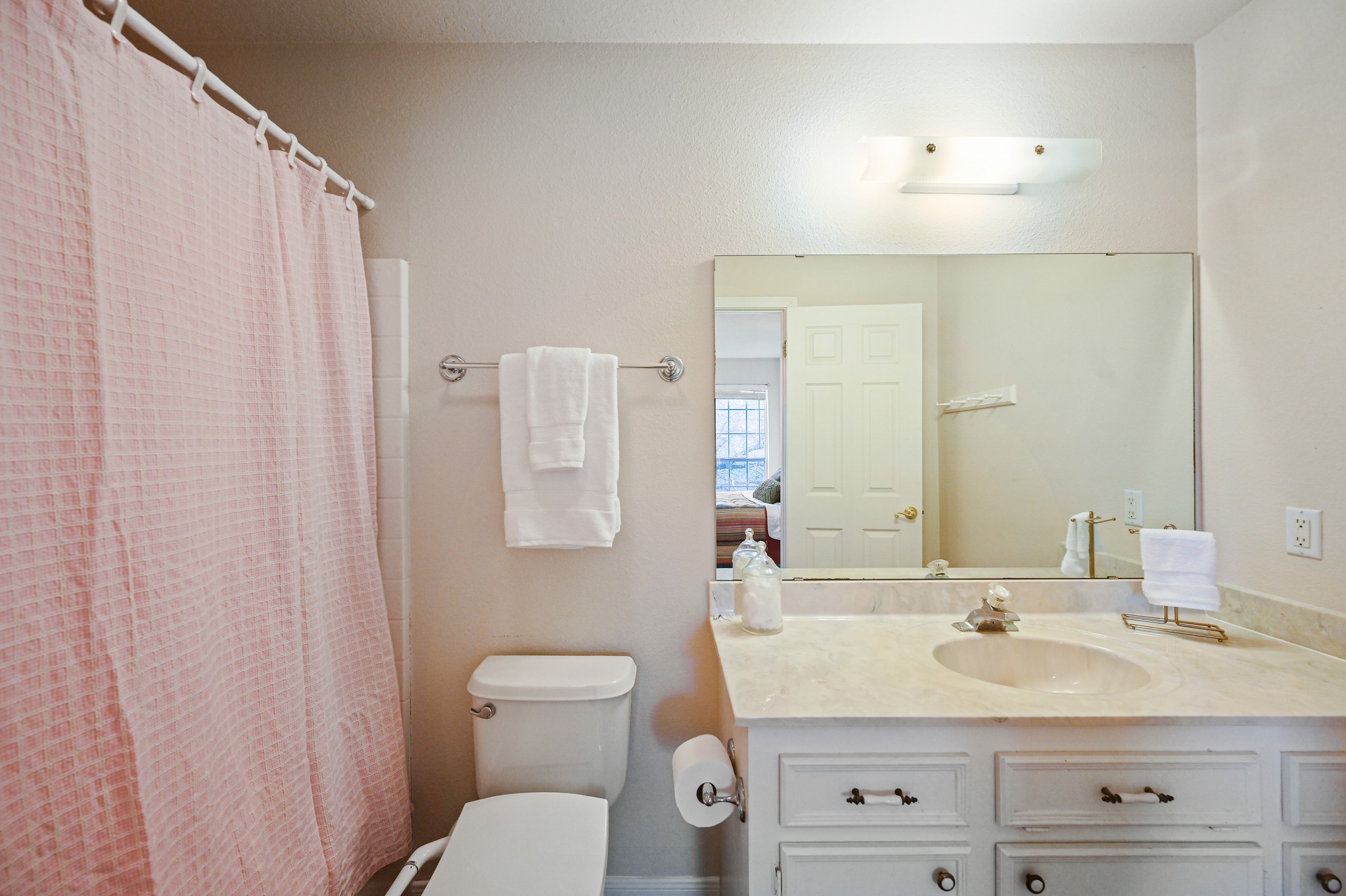 364 Nameless Road Driftwood, TX 78619 - Photo 23 of 32 An inviting full bathroom showcases a vanity with a large mirror and shower area.