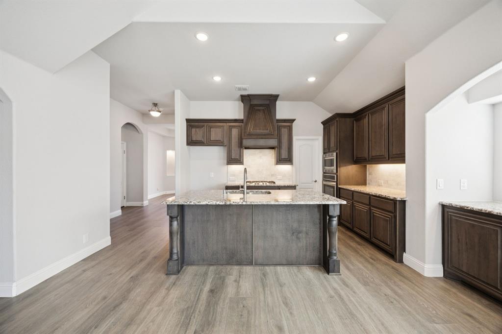 1036 Sandy Hill Burleson, TX 76028 - Photo 11 of 37 a large kitchen with stainless steel appliances granite countertop a stove and a sink