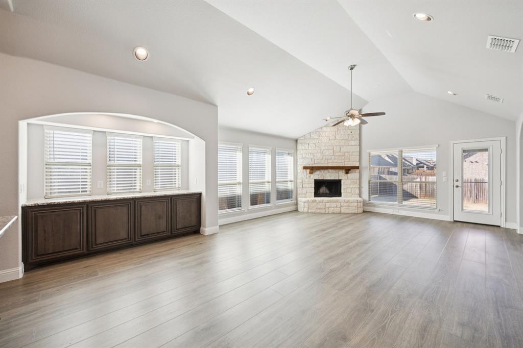 1036 Sandy Hill Burleson, TX 76028 - Photo 15 of 37 an empty room with wooden floor and fireplace