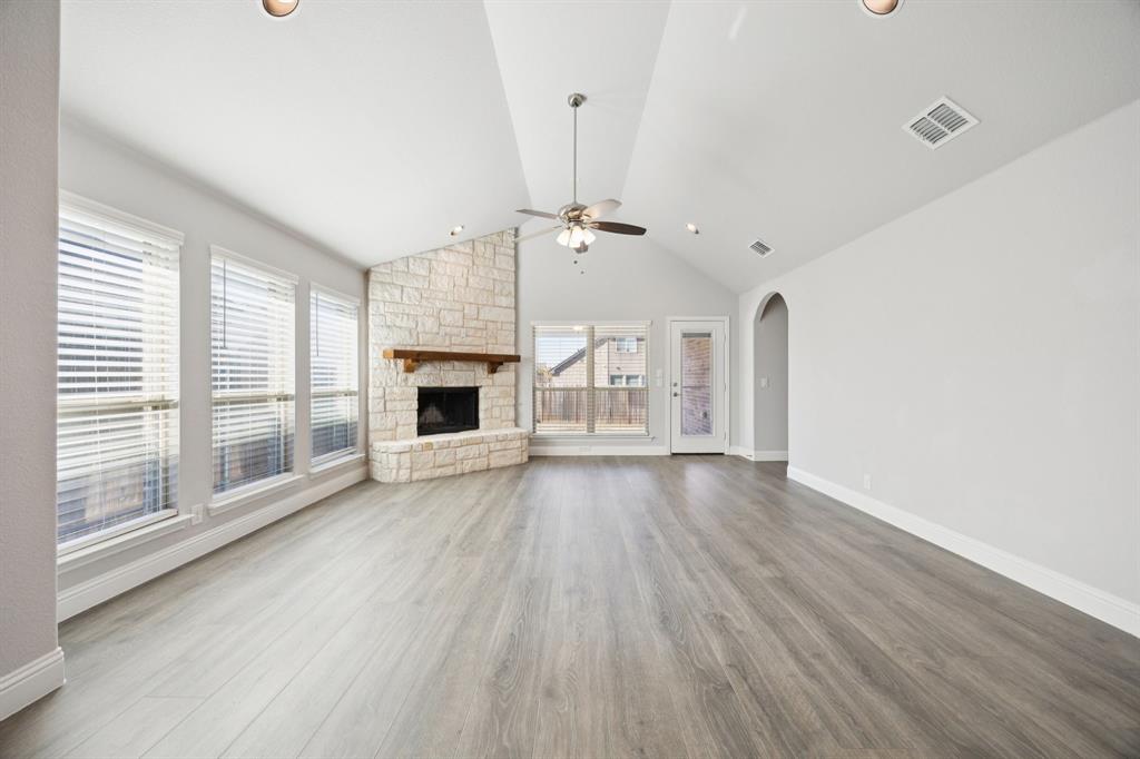 1036 Sandy Hill Burleson, TX 76028 - Photo 16 of 37 wooden floor in an empty room with a fireplace