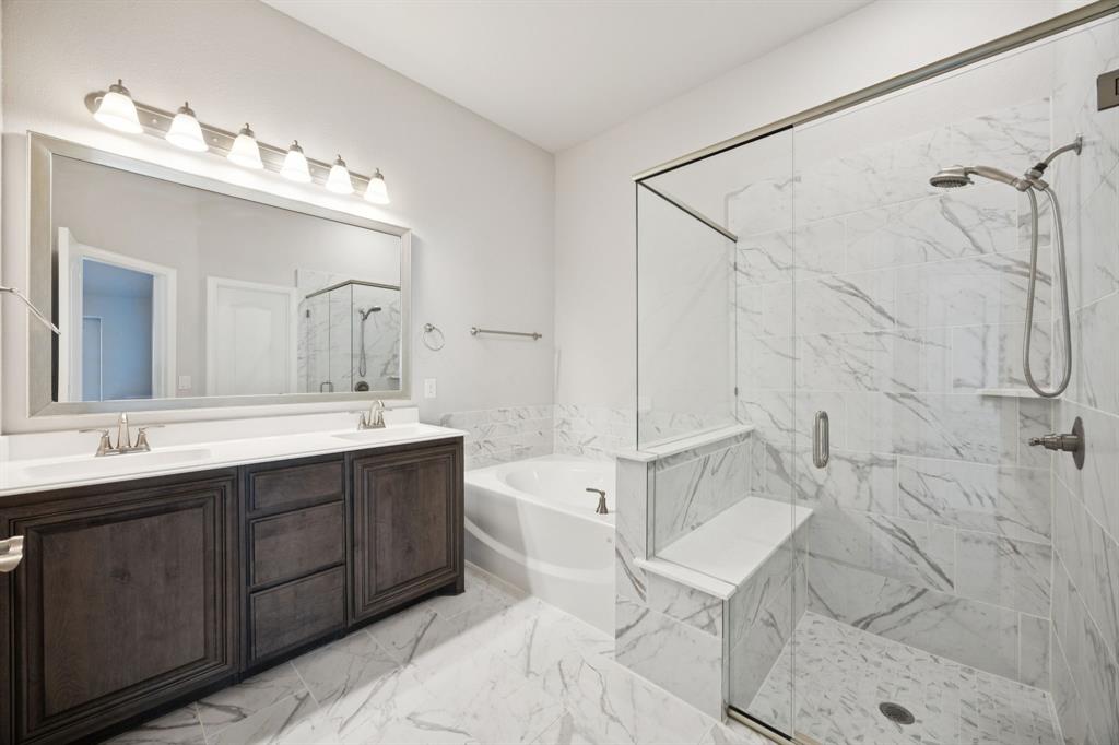 1036 Sandy Hill Burleson, TX 76028 - Photo 23 of 37 a spacious bathroom with a bathtub shower sink mirror and toilet