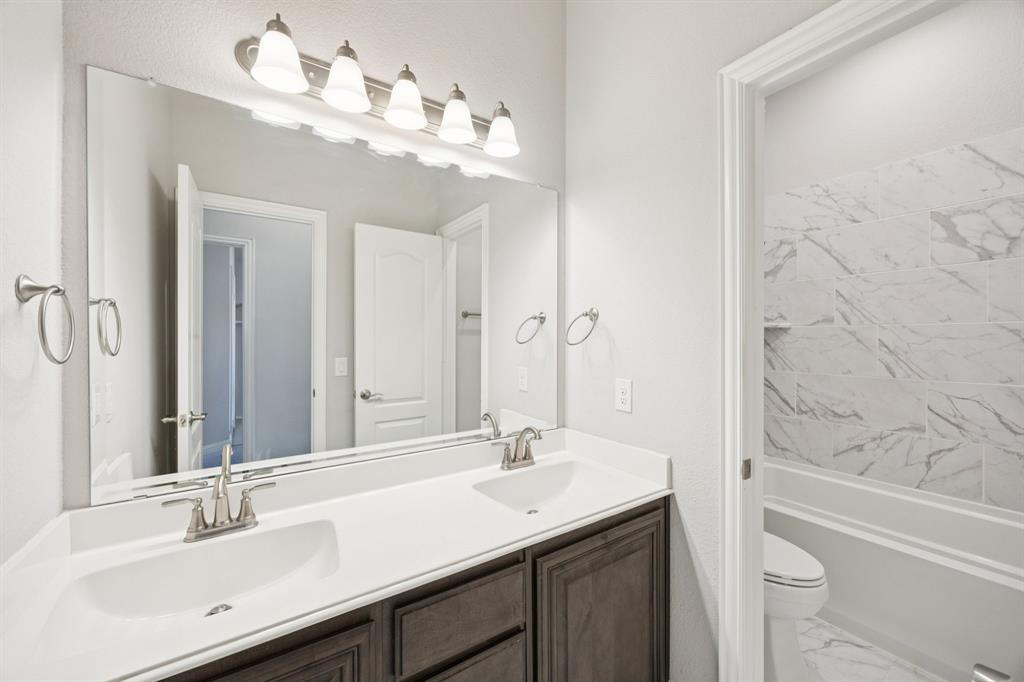 1036 Sandy Hill Burleson, TX 76028 - Photo 31 of 37 a bathroom with a sink vanity granite tub and a mirror