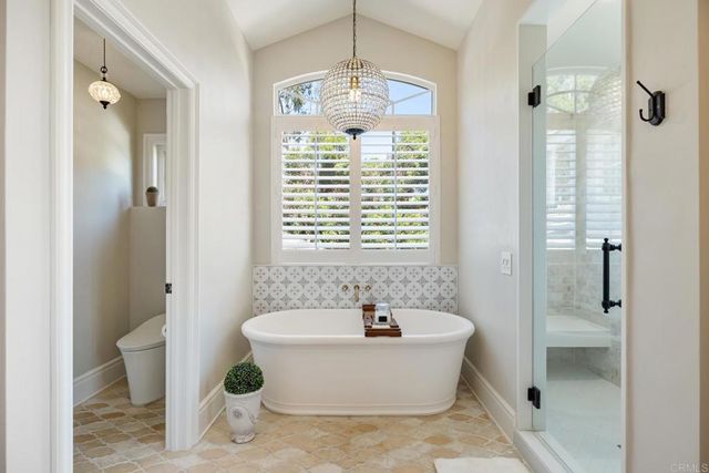 a bathroom with a sink mirror and shower