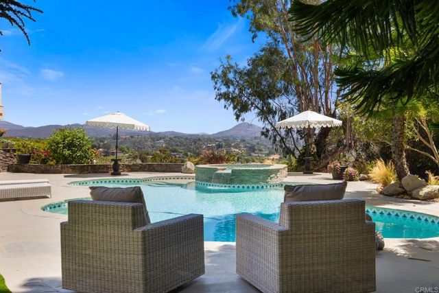 a view of a balcony with furniture and a potted plant