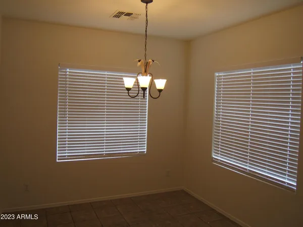 a view of a room with a window and ceiling fan