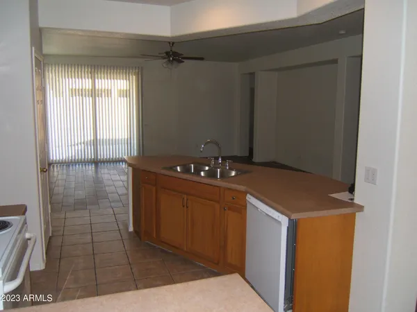 a room with granite countertop a sink a toilet and shower