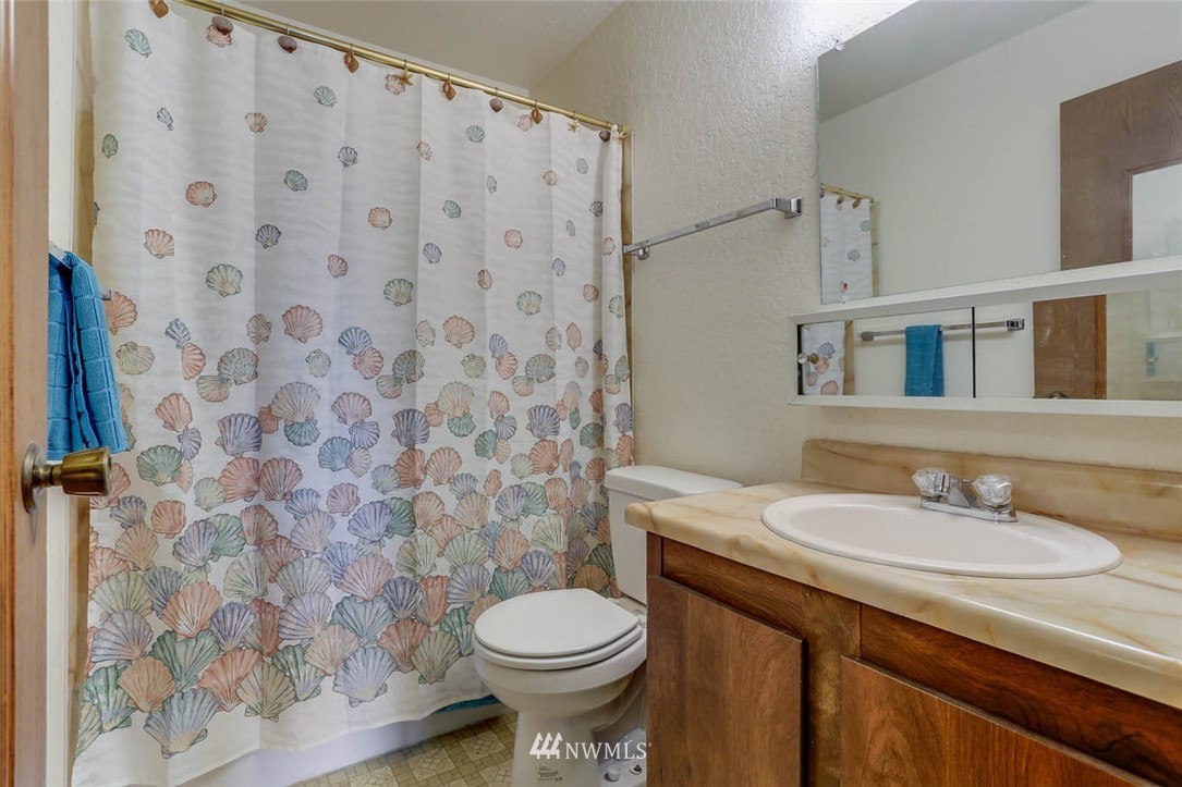 14401 Southeast Petrovitsky Road, Unit F203 Renton, WA 98058 - Photo 12 of 16 a bathroom with a sink and a toilet