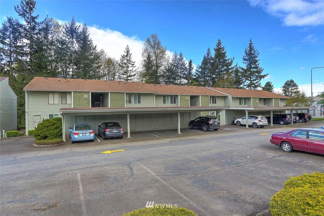 14401 Southeast Petrovitsky Road, Unit F203 Renton, WA 98058 - Photo 13 of 16 a view of house with outdoor space and car parked