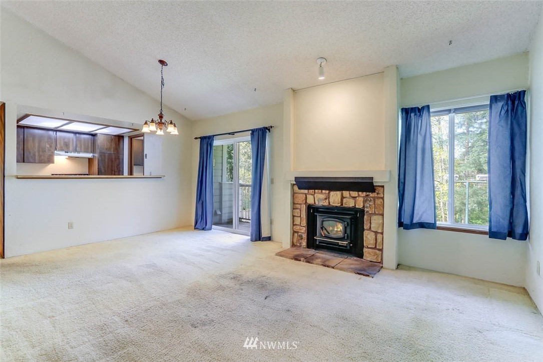 14401 Southeast Petrovitsky Road, Unit F203 Renton, WA 98058 - Photo 3 of 16 a view of a livingroom with a fireplace and window
