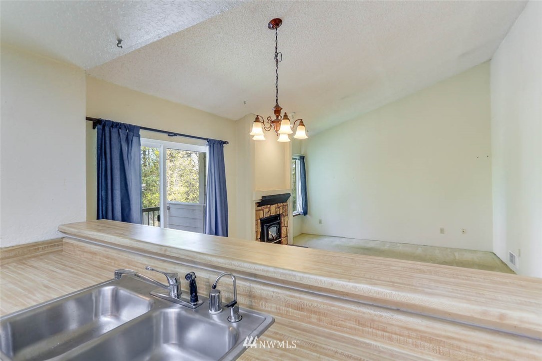 14401 Southeast Petrovitsky Road, Unit F203 Renton, WA 98058 - Photo 4 of 16 a view of a room with a chandelier
