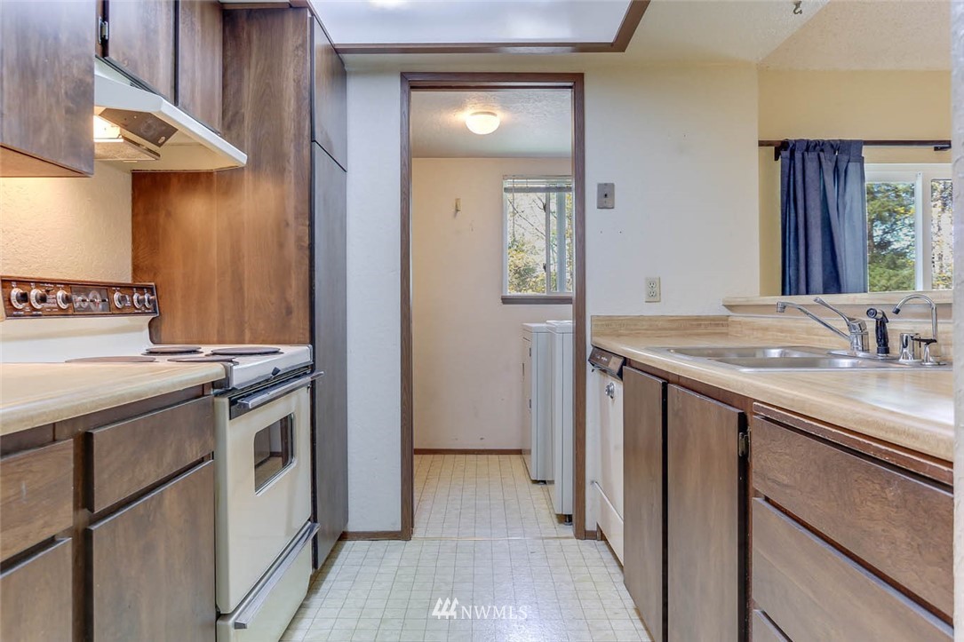 14401 Southeast Petrovitsky Road, Unit F203 Renton, WA 98058 - Photo 5 of 16 a kitchen with a sink and a stove top oven