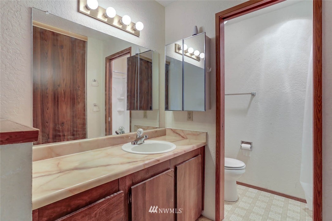 14401 Southeast Petrovitsky Road, Unit F203 Renton, WA 98058 - Photo 10 of 16 a bathroom with a sink vanity and a mirror