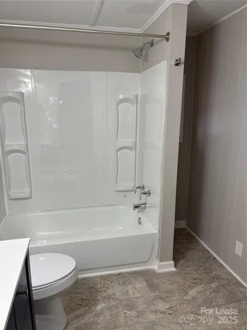 an empty room with wooden floor and window