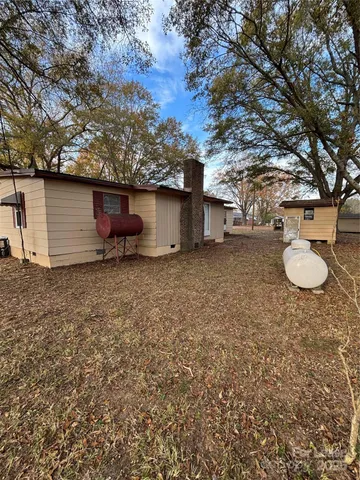 a view of a field with trees in the background