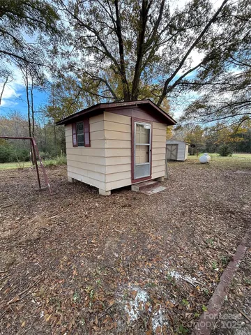 a view of a backyard with large trees