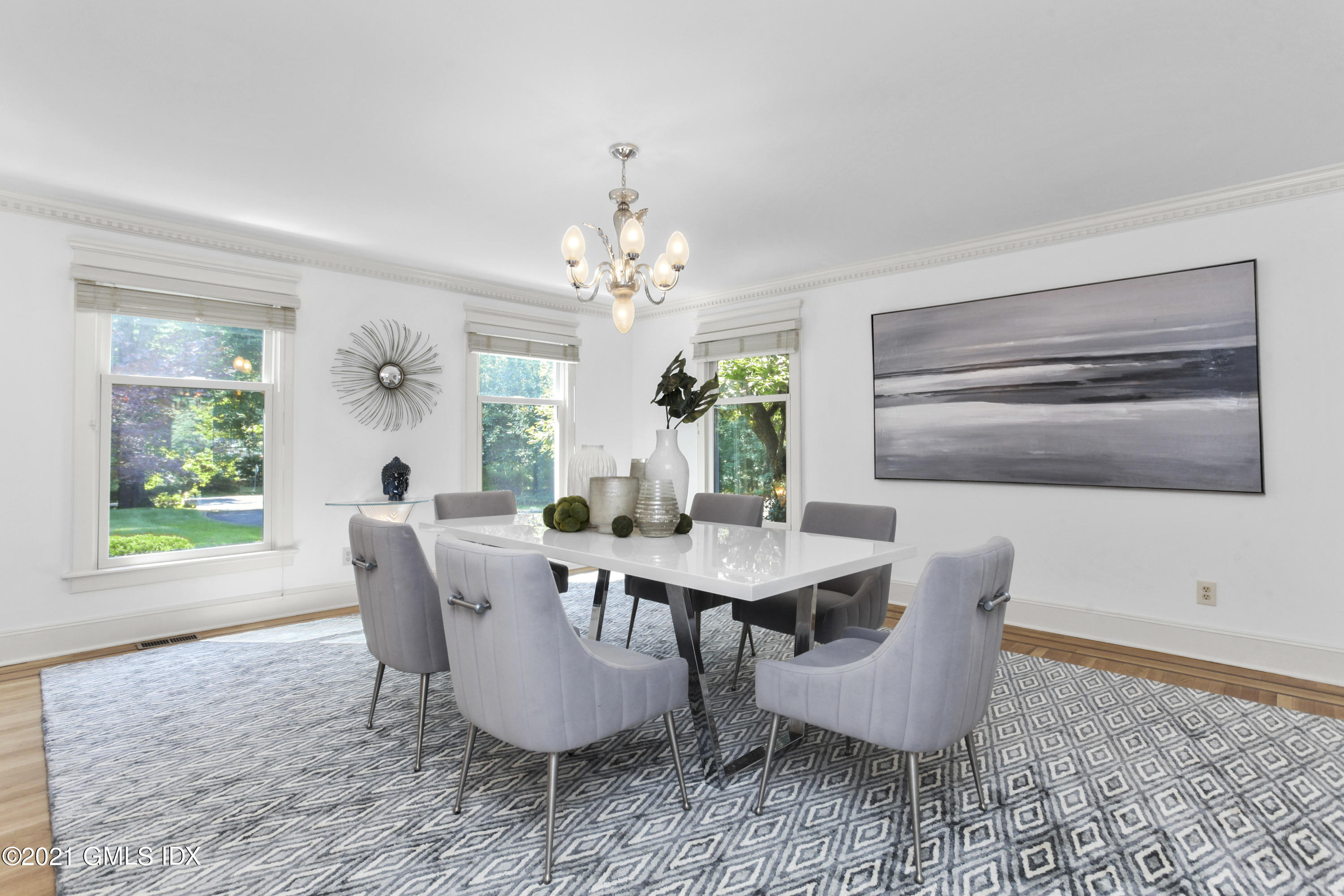 150 Porchuck Road Greenwich, CT 06831 - Photo 7 of 21 a dining room with furniture a rug a potted plant and a chandelier