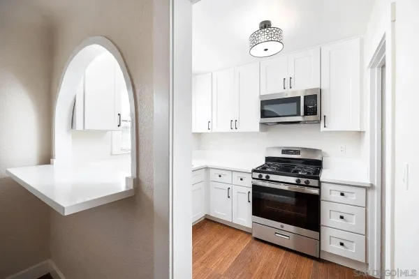 a kitchen with stainless steel appliances a white stove top oven and sink