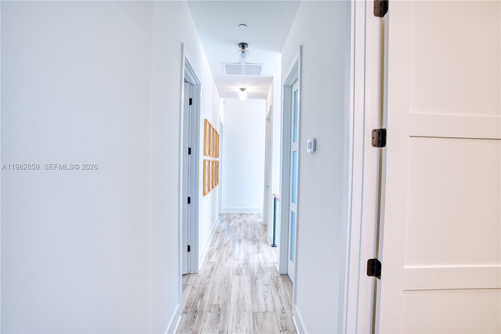 5120 Watersong Way Fort Pierce, FL 34949 - Photo 49 of 70 a view of a hallway with wooden floor