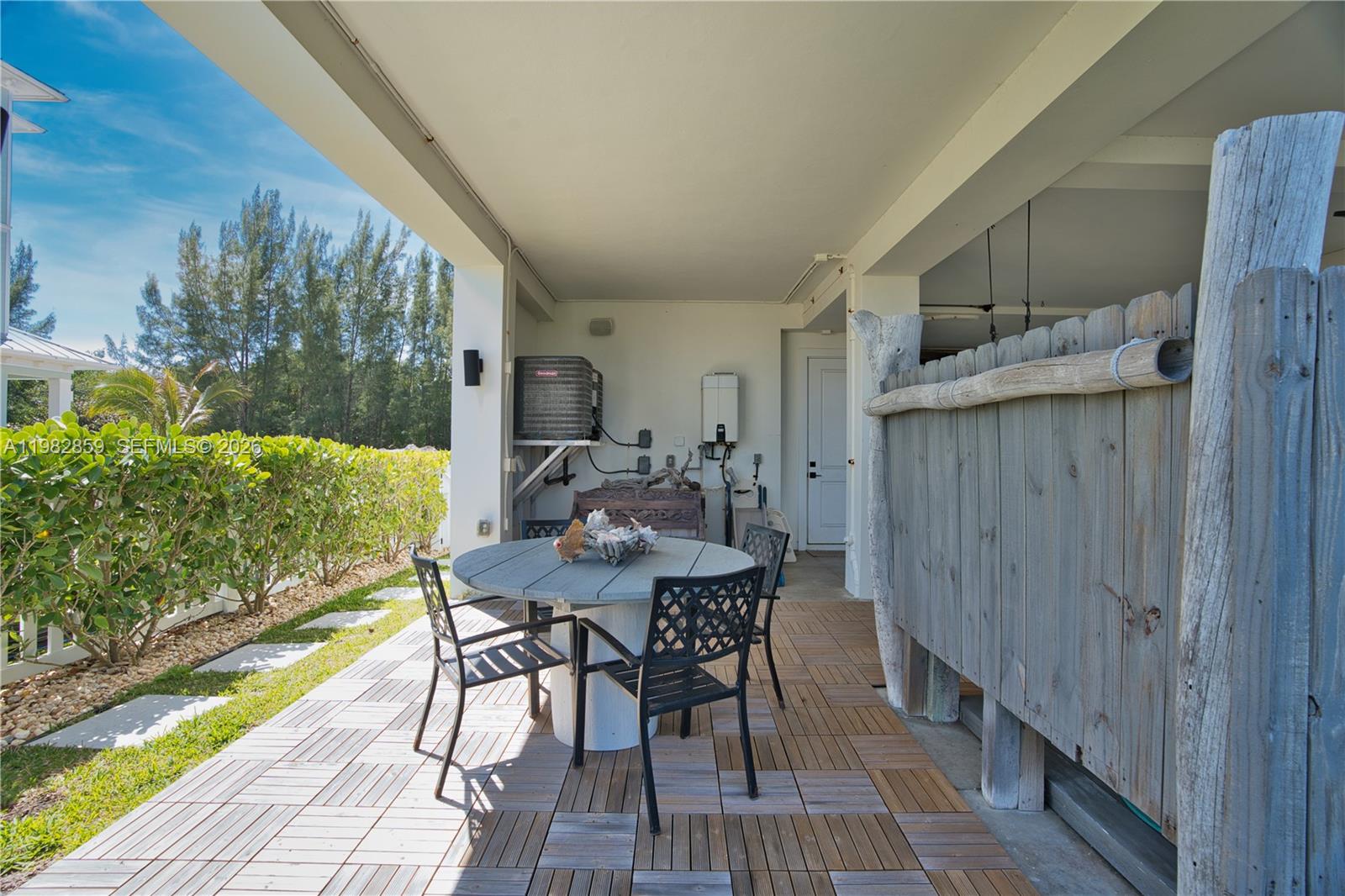 5120 Watersong Way Fort Pierce, FL 34949 - Photo 55 of 70 a view of a patio with table and chairs and potted plants