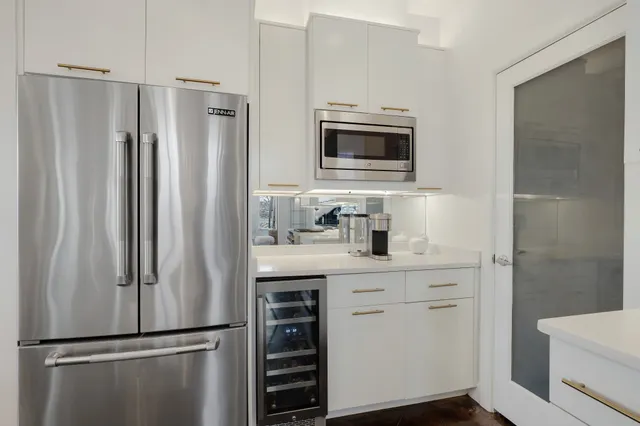 a kitchen with a refrigerator sink and microwave