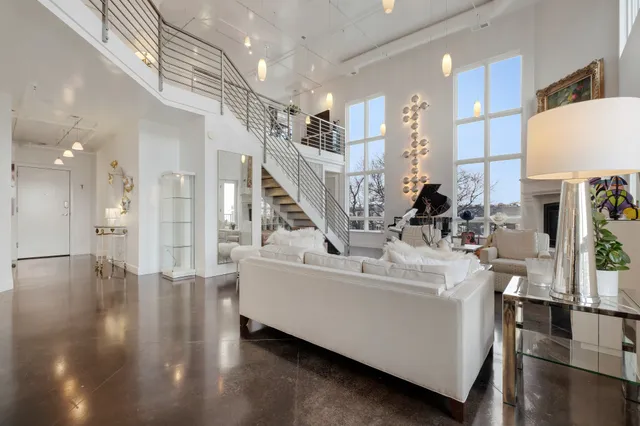 a very nice looking room with many windows and furniture