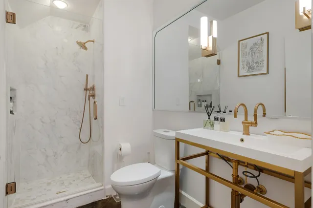 a bathroom with a sink toilet and shower