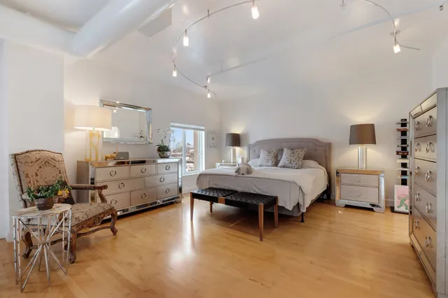 a bedroom with furniture and a wooden floor