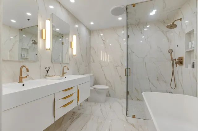 a bathroom with a double vanity sink mirror and shower