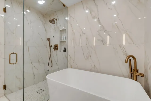 a bathroom with a sink a toilet and a shower