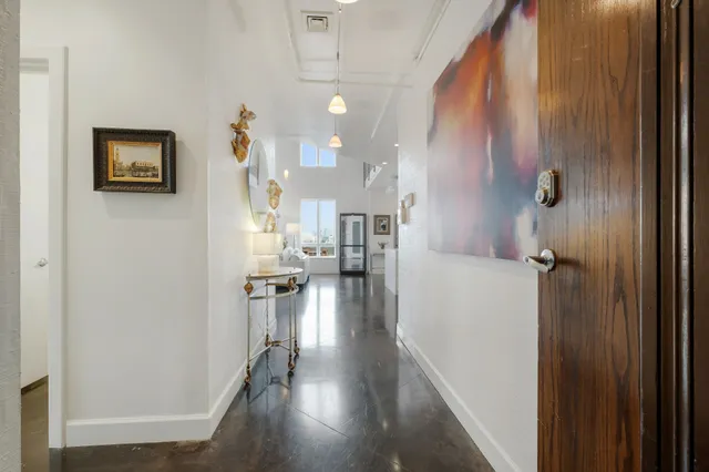 a view of a hallway with wooden floor windows and livingroom view