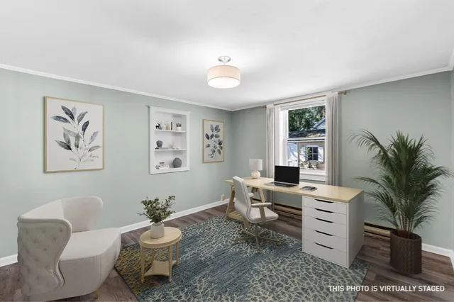 a living room with furniture a window and a potted plant