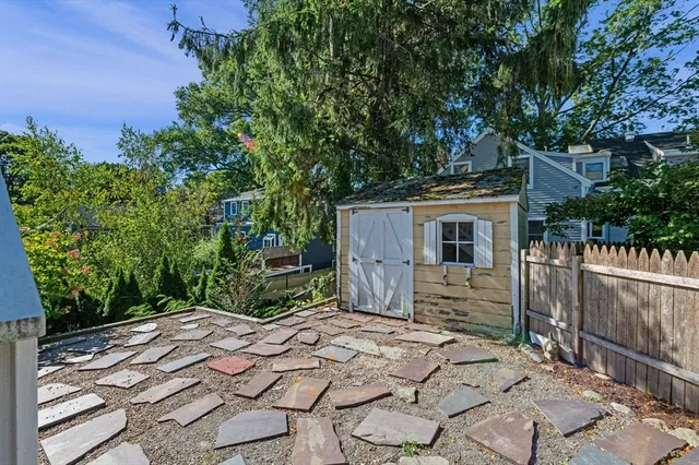 a view of a backyard that has a large tree