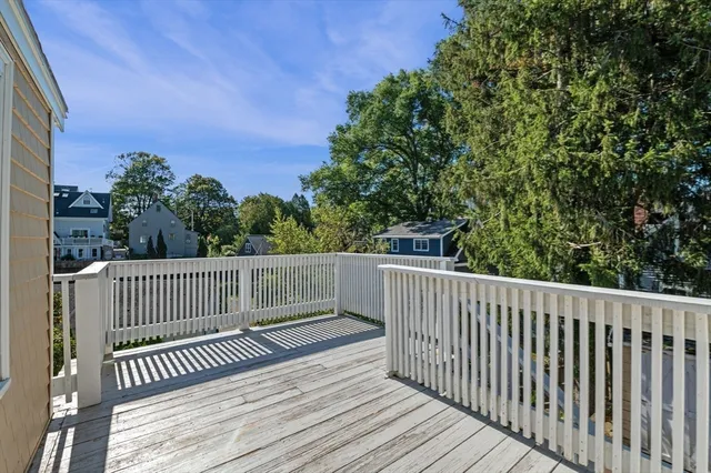 a view of balcony with wooden floor and fence